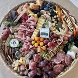 A vibrant charcuterie board brimming with premium meats, cheeses, fresh fruits, nuts, and crackers - designed to impress and satisfy every guest!