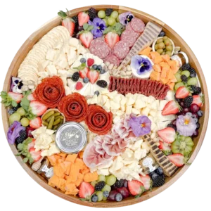 Large charcuterie board in Orange County by Fork and Flare featuring artisan cured meats, prosciutto, salami, manchego, brie, gouda, espresso cheddar, wine cheese, sheep’s milk and goat cheeses, olives, cornichons, fresh berries, grapes, honeycomb, fig jam, and stone ground mustard for catering or delivery.