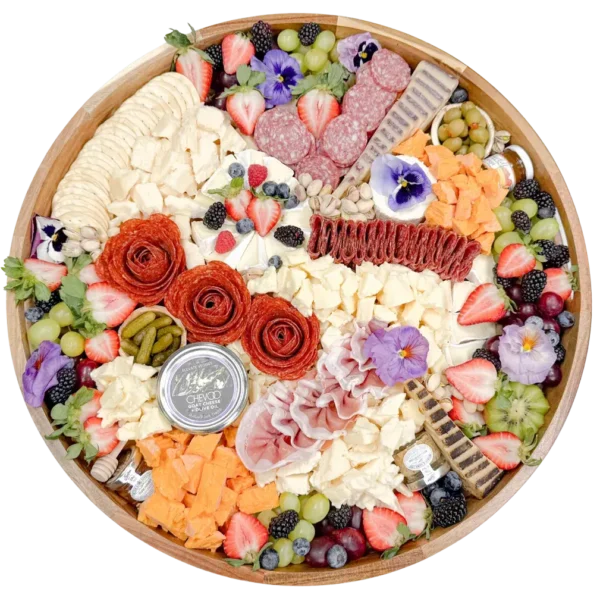 Large charcuterie board in Orange County by Fork and Flare featuring artisan cured meats, prosciutto, salami, manchego, brie, gouda, espresso cheddar, wine cheese, sheep’s milk and goat cheeses, olives, cornichons, fresh berries, grapes, honeycomb, fig jam, and stone ground mustard for catering or delivery.