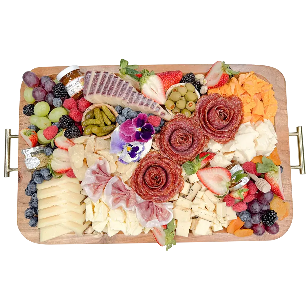 Charcuterie board from Fork and Flare in Orange County featuring hand cut salami and prosciutto, manchego, brie, gouda, wine cheese, espresso cheddar, rustic red cheddar, Boursin, sheep’s milk and goat cheeses, olives, cornichons, fresh berries and grapes, served with honey, jam and stone ground mustard for delivery or pickup.