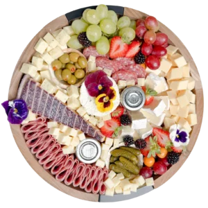 Top view of a small charcuterie board by Fork and Flare in Orange County featuring borsin cheese, brie cheese, white cheddar cheese, gouda cheese, bellavitano cheese, assorted cured meats and salami, fresh grapes, strawberries, blackberries, gooseberries, olives, cornichons, honey, and jam arranged in an artisan, gourmet presentation showcasing the best charcuterie in Orange County.