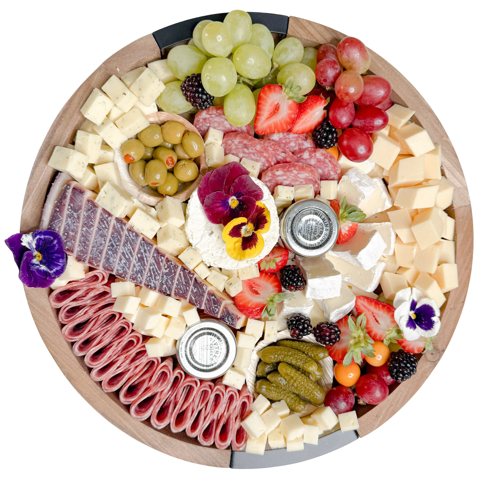 Top view of a small charcuterie board by Fork and Flare in Orange County featuring borsin cheese, brie cheese, white cheddar cheese, gouda cheese, bellavitano cheese, assorted cured meats and salami, fresh grapes, strawberries, blackberries, gooseberries, olives, cornichons, honey, and jam arranged in an artisan, gourmet presentation showcasing the best charcuterie in Orange County.