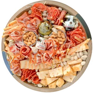 12-inch spicy charcuterie board featuring chili garlic cashews, cajun cheddar, smoked gouda, scotch bonnet cheddar, spicy cornichons, jalapeño jam, hot sopressata salami, spicy prosciutto, uncured hot copa, chorizo with paprika and oregano, chili crackers, pistachios, and Mike’s Hot Honey — Fork and Flare Orange County catering.