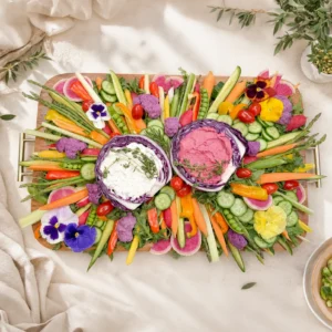 stunning crudités platter by Fork and Flare featuring fresh seasonal vegetables, edible flowers, cabbage bowls with dips, and a styled catering presentation for Orange County events.