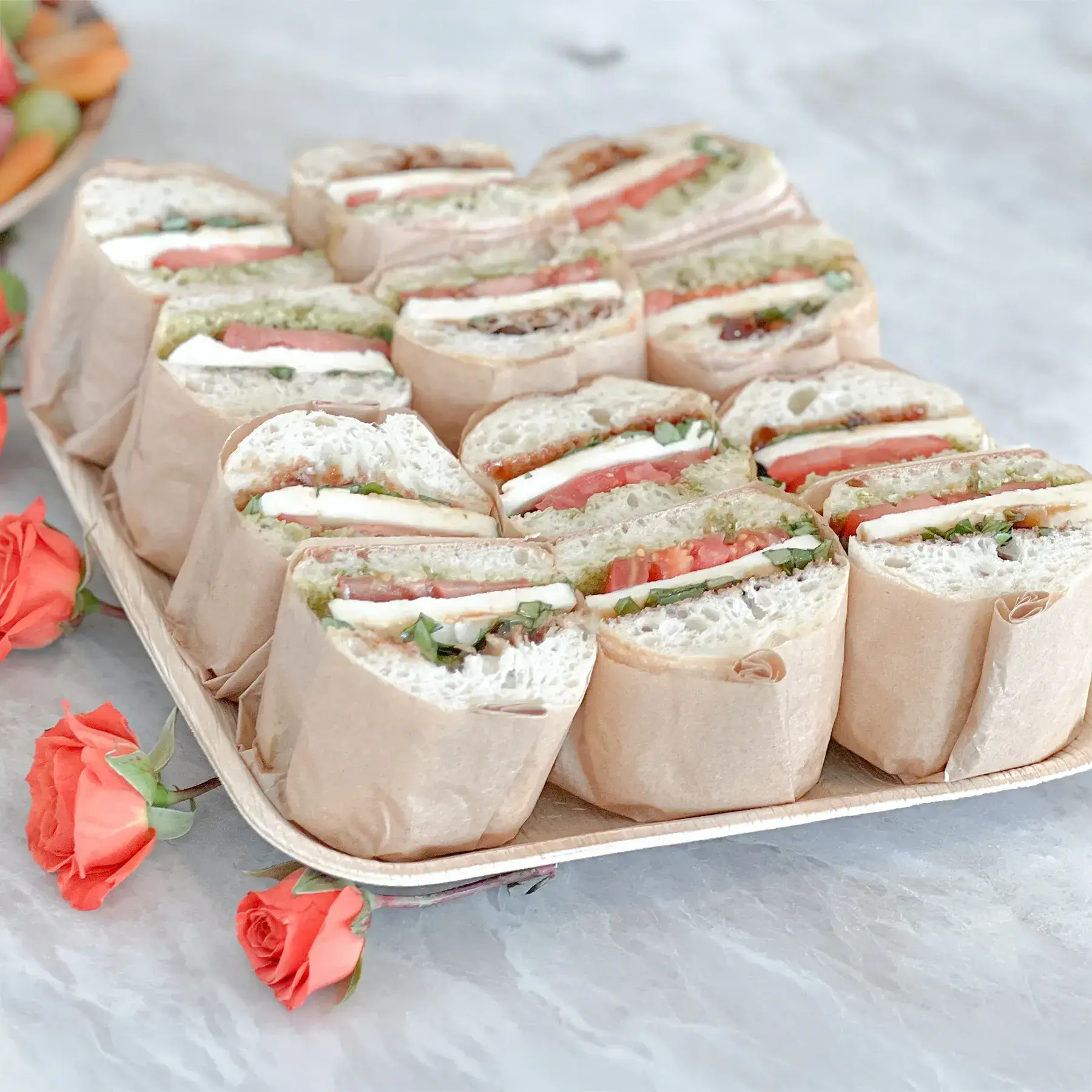 Sandwich catering in Irvine CA by Fork and Flare featuring gourmet finger sandwiches and mini sandwiches served at a real estate open house with fresh baked bread, turkey and cheese, roast beef and cheddar, and vegetarian options arranged on platters.