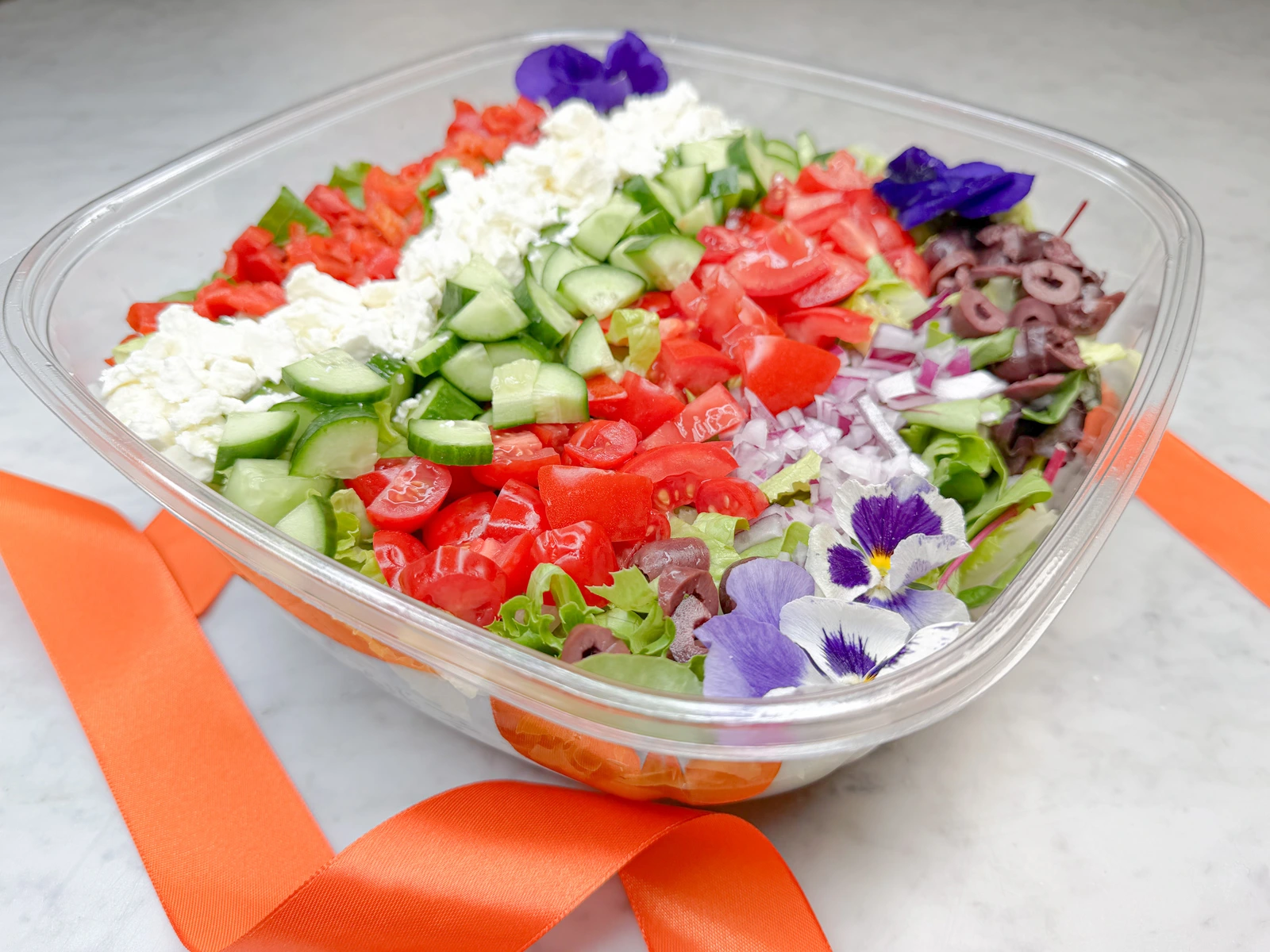 Large 160 ounce Chopped Mediterranean Salad in Orange County by Fork and Flare featuring fresh chopped romaine lettuce, diced red onion, Kalamata olives, tomatoes, cucumber, and creamy feta, presented as a vibrant gourmet salad and promoted as the best salad in Orange County