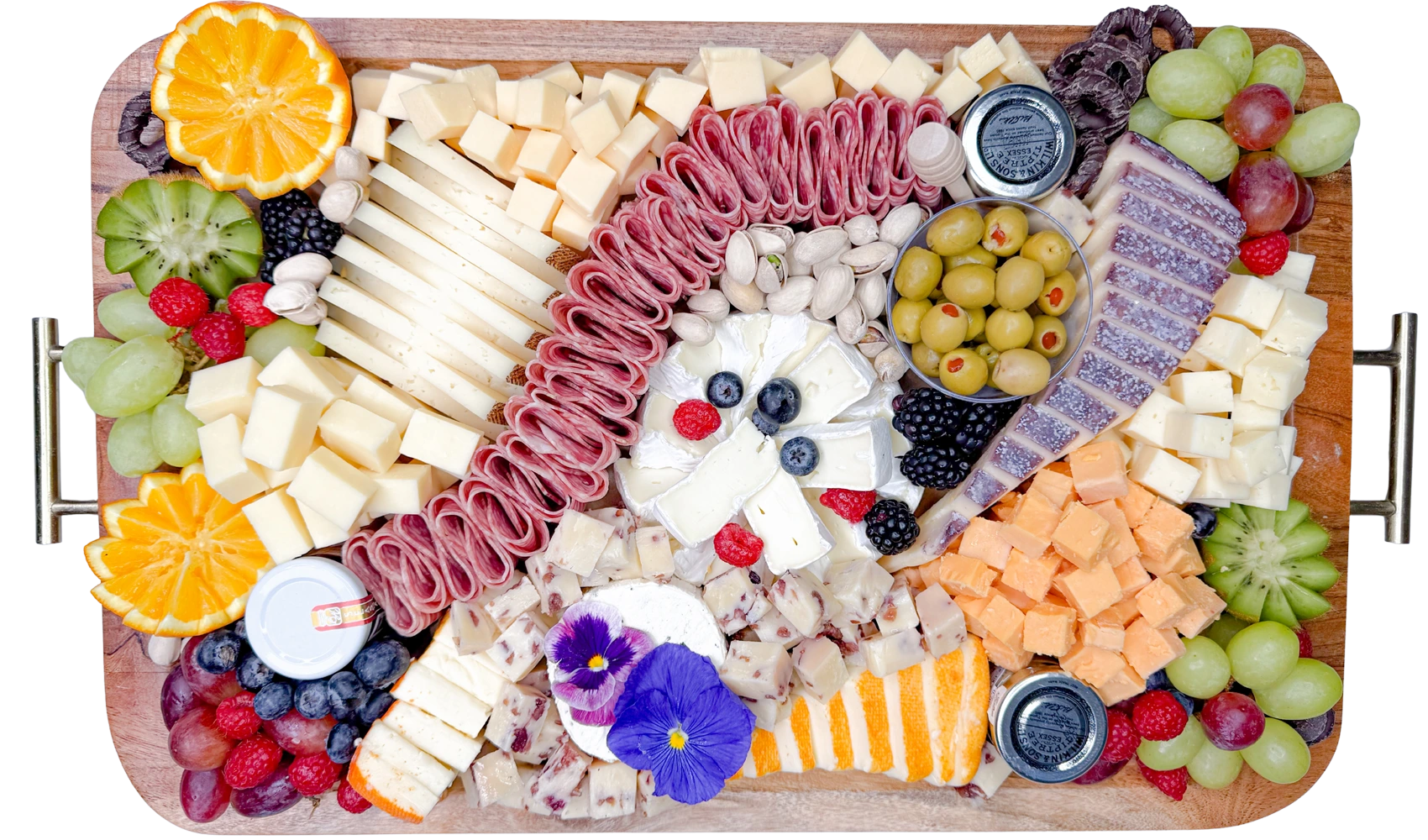 Best charcuterie boards in Orange County displayed on a Fork and Flare board featuring fresh salami, brie, cranberry cheddar, cheddar, gouda, manchego, bellavitano, grapes, oranges, kiwi, strawberries, blueberries, blackberries, chocolate-dipped pretzels, pistachios, honey, jam, and stone ground mustard
