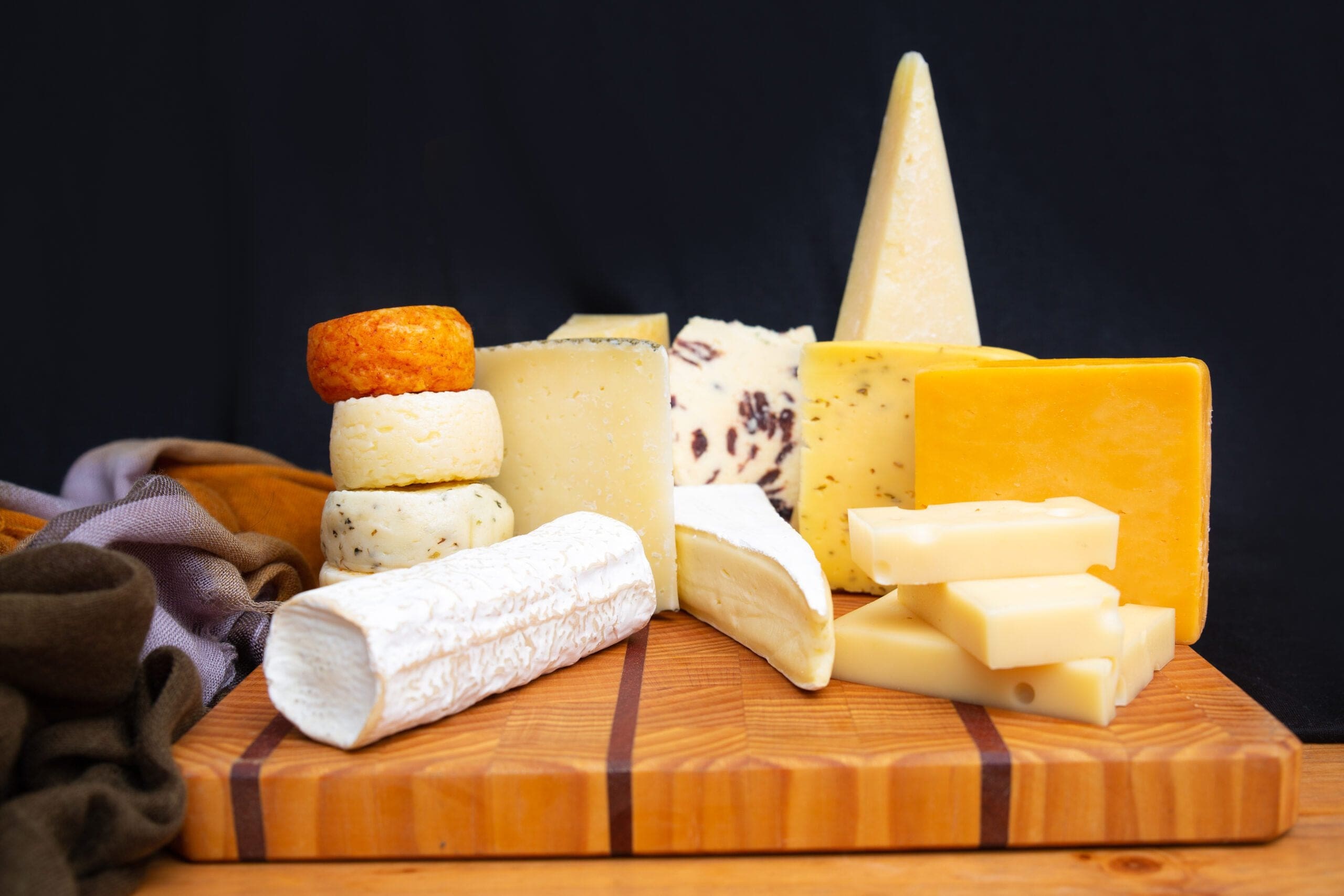 classic-different-cheeses-laying-wooden-board