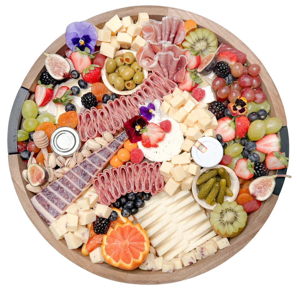 Best Charcuterie Board in Orange County featuring Gouda, Manchego, Brie, Prosciutto, fresh fruit, nuts, and honey, handcrafted catering display.